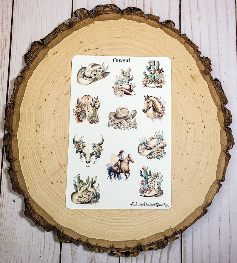 May include: A sheet of stickers with a western theme. The stickers feature cowboy hats, cacti, boots, a skull, a horse, and the text "Cowgirl".