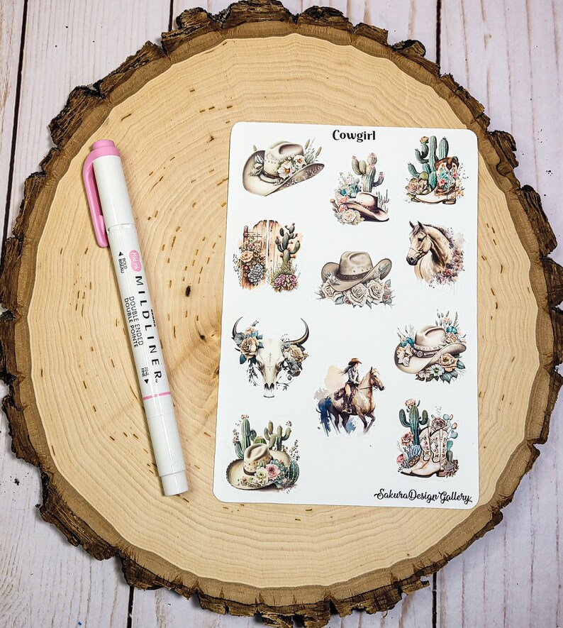 May include: A sheet of stickers with a western theme. The stickers feature a variety of images, including cowboy hats, cacti, boots, a skull, and a horse. The text "Cowgirl" and "Sakura Design Gallery" are printed on the sheet.