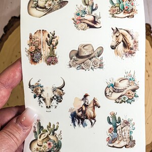 May include: A sheet of 10 colorful stickers featuring a cowgirl theme. The stickers include images of cowboy hats, cacti, boots, a skull, a horse, and a cowgirl riding a horse. The stickers are perfect for adding a touch of western flair to your planner, laptop, or water bottle.