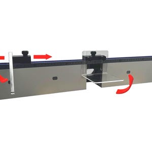 May include: A silver-colored woodworking tool with a clear plastic guide and black adjustment knobs. The tool has a ruler with measurements and is designed for precise cutting and alignment. Red arrows indicate adjustable parts.