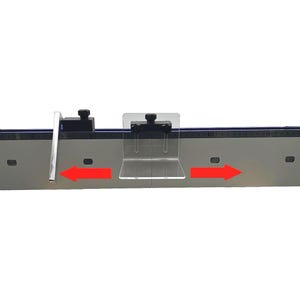 May include: A silver-colored woodworking tool with a black ruler and clear plastic components. The tool has two black knobs and red arrows indicating direction. The tool is designed for precise measurements and cuts.
