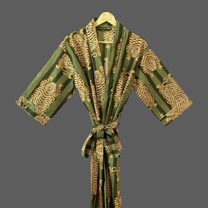 May include: Green and gold striped robe with a tiger print. The robe has a sash tie and is hanging on a wooden hanger.