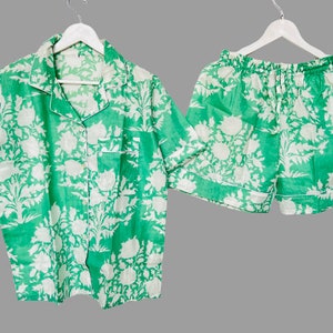 May include: A green and white floral print pajama set with a short-sleeved button-up shirt and matching shorts.