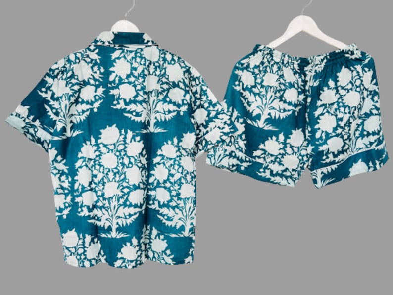 May include: A teal blue and white floral print pajama set with a short-sleeved button-up shirt and matching shorts.