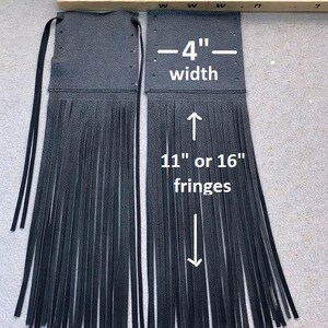 May include: Two black leather fringe pieces, each 4 inches wide, with fringe lengths of either 11 or 16 inches. The pieces have a textured surface and are designed with a top section and long fringe.