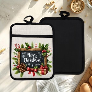 May include: Two Christmas-themed pot holders. One features a black chalkboard design with the words "Merry Christmas" surrounded by holly, berries, a pinecone, and a gift. The other pot holder is solid black.