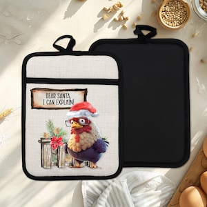 May include: A pair of Christmas-themed oven gloves. One glove features a cartoon chicken wearing a Santa hat and glasses, with the text "DEAR SANTA, I CAN EXPLAIN!". The other glove is solid black.