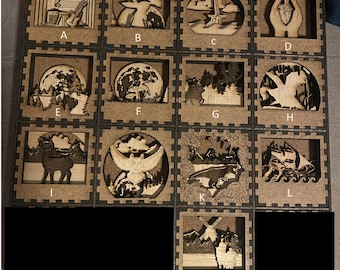 May include: A wooden laser-cut art piece featuring various nature and fantasy-themed designs. The designs include a guitar, rabbits, a sword, a heart, a deer, a mushroom, a dragon, a ship, and more. The art is displayed in individual square frames.