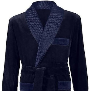 May include: A navy blue velvet robe with a quilted collar and cuffs. The robe has a self-tie belt and two patch pockets.