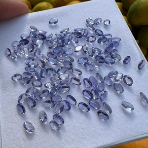 Tanzanite Gemstone Lot: 100 Faceted Oval Cut Stones, 60 Carat