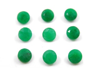 May include: Nine round, faceted, bright green gemstones are arranged on a white background. The gemstones have a polished, reflective surface, and are evenly spaced. The gems are a vibrant, saturated green colour.