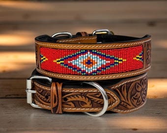 May include: Two dog collars. The top collar has a red beaded design with a central geometric pattern in blue, white, yellow, and orange. The bottom collar is brown leather with a floral embossed design and a silver buckle.