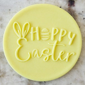 May include: Yellow round cookie cutter with the text "Hoppy Easter" and a bunny rabbit silhouette.