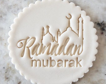 May include: White clay cookie stamp with a mosque silhouette and the text "Ramadan Mubarak".