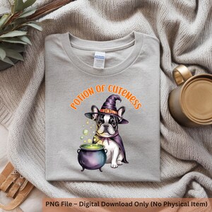 May include: A light gray t-shirt featuring a French bulldog wearing a witch hat and cape, with a cauldron and the text "Potion of Cuteness". The graphic is in shades of purple, green, black, and white.