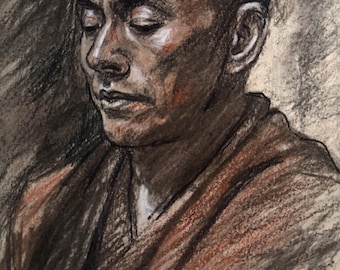 May include: A charcoal and pastel drawing on paper depicting a person with a shaved head and closed eyes, wearing a draped garment. The artwork uses shades of black, brown, and white to create depth, texture, and highlights on the face and shoulders.