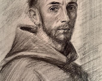 May include: A charcoal drawing on paper depicting a portrait of a person with short hair and a light beard, wearing a hooded garment. The artwork features expressive shading and textured lines, capturing the facial features and the folds of the fabric.