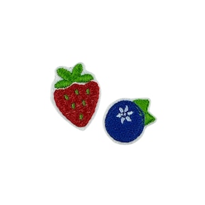 May include: Two embroidered iron-on patches, one of a red strawberry and one of a blue blueberry.