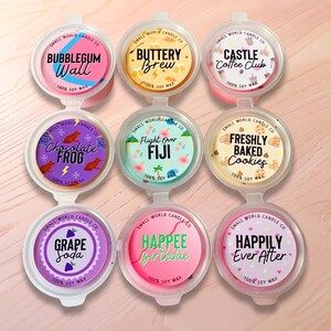 May include: Nine soy wax melt containers with various scents. Each container has a different label with text such as "Bubblegum Wall", "Buttery Brew", and "Castle Coffee Club". The containers are in a variety of colors, including pink, yellow, and purple.