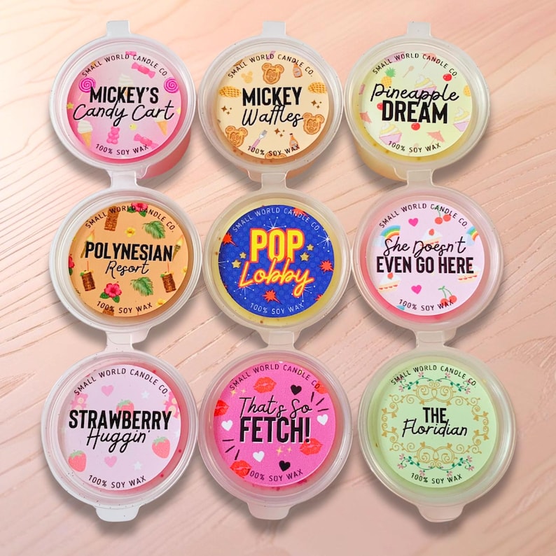 May include: Nine small, round, soy wax candle melts in clear plastic containers. Each lid features a different design and text, including "Mickey's Candy Cart," "Mickey Waffles," and "Pineapple Dream."
