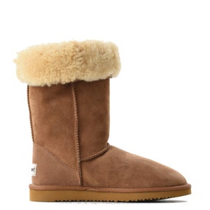 May include: Brown sheepskin boots with a fold-over cuff and a brown suede sole.