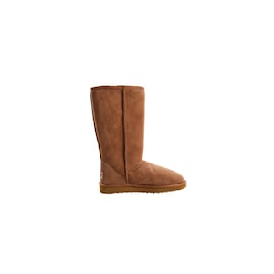 May include: A pair of brown tall sheepskin boots with a suede finish and a brown rubber sole.
