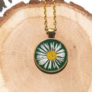 Pressed daisy necklace with forest green background