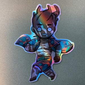 May include: A holographic sticker of a cartoon character with brown hair, horns, and a striped shirt. The character is wearing a tropical print shirt and shorts. The sticker has a rainbow iridescent finish.