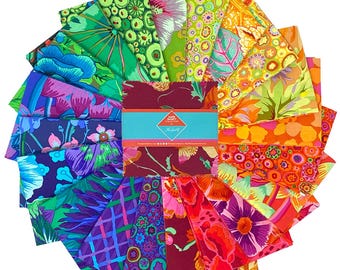 May include: A collection of colorful fabric squares arranged in a circular pattern. The fabrics feature vibrant floral and abstract designs in shades of green, blue, purple, orange, and red. A teal band with text is in the center.