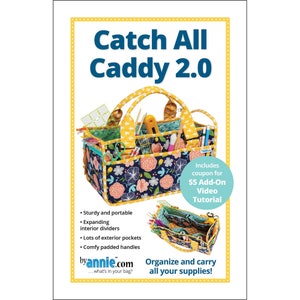 May include: Catch All Caddy 2.0, a sturdy and portable organizer with expanding interior dividers, exterior pockets, and comfy padded handles. The caddy features a floral pattern with a yellow handle and trim. Includes a coupon for a video tutorial.