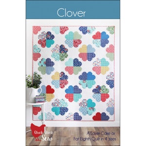 May include: A white quilt with large, four-leaf clover designs in various colors and patterns. The quilt features red, blue, yellow, and green clover shapes. The word "Clover" is at the top, and the text "A Layer Cake or Fat Eighth Quilt in 4 sizes" is at the bottom.