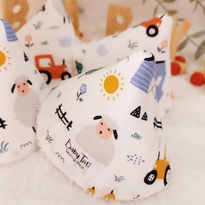 May include: Three white fabric baby burp cloths with a farm theme. The cloths feature a tractor, sheep, sun, and fence. The text "Baby Tatt Sewing Shop" is printed on one of the cloths.