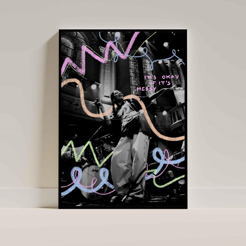 May include: Black and white photograph of a person singing on stage with colourful scribbles and the text "It's okay if it's messy" on a black background.