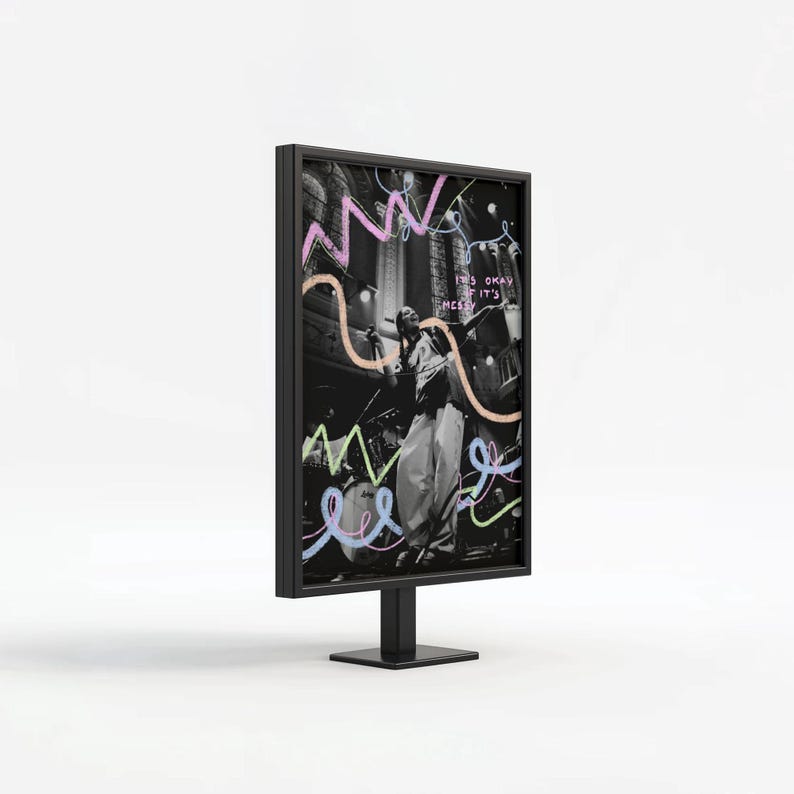 May include: Black and white photograph of a person singing on stage with a microphone. The photo is framed in a black frame and has colourful abstract doodles around it. The text "It's okay if it's messy" is written in pink on the photo.