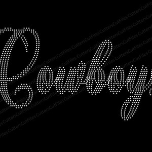 May include: A white rhinestone design of the word "Cowboys" in a cursive font.