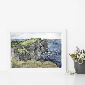 Puede incluir: Pintura acuarela de un acantilado con vistas a un oc&eacute;ano azul. El acantilado es verde en la parte superior y gris oscuro en la parte inferior. El oc&eacute;ano es de un azul profundo con olas blancas.