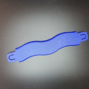 May include: A blue plastic track piece for a toy race car set. The piece is shaped like a curved S and has two small loops on either end.