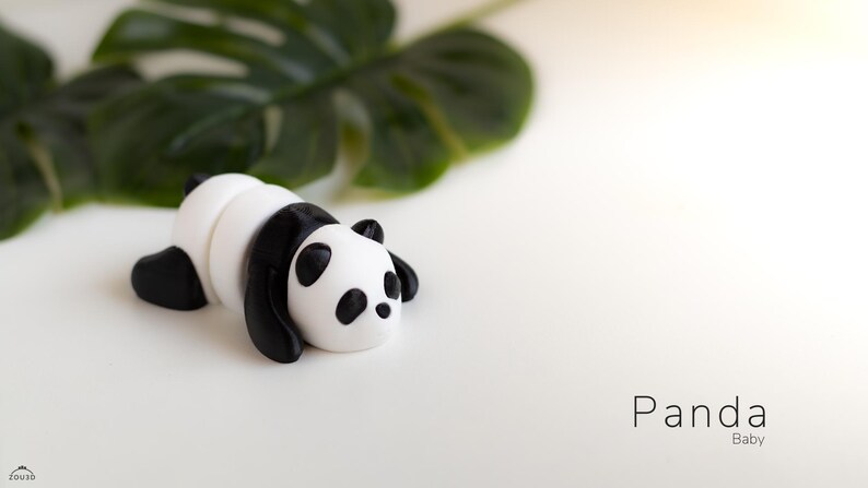 PandaTwirl™ Baby Panda Fidget Keyring: "A miniature, hand-painted panda keychain, featuring a baby panda in a sitting position. The panda has big, round eyes, a soft white and black color scheme, and a smooth surface.