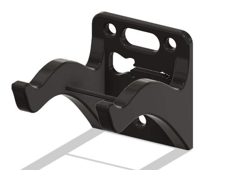 May include: Black wall mount with two curved arms for hanging a guitar. The mount has a cutout in the shape of a guitar.