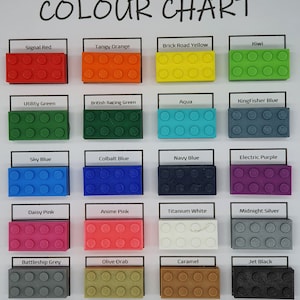 May include: Color chart with 18 different colors of plastic building blocks. The colors include signal red, tangy orange, brick road yellow, kiwi, utility green, British racing green, aqua, kingfisher blue, sky blue, cobalt blue, navy blue, electric purple, daisy pink, anime pink, titanium white, midnight silver, battleship grey, olive drab, caramel, and jet black.