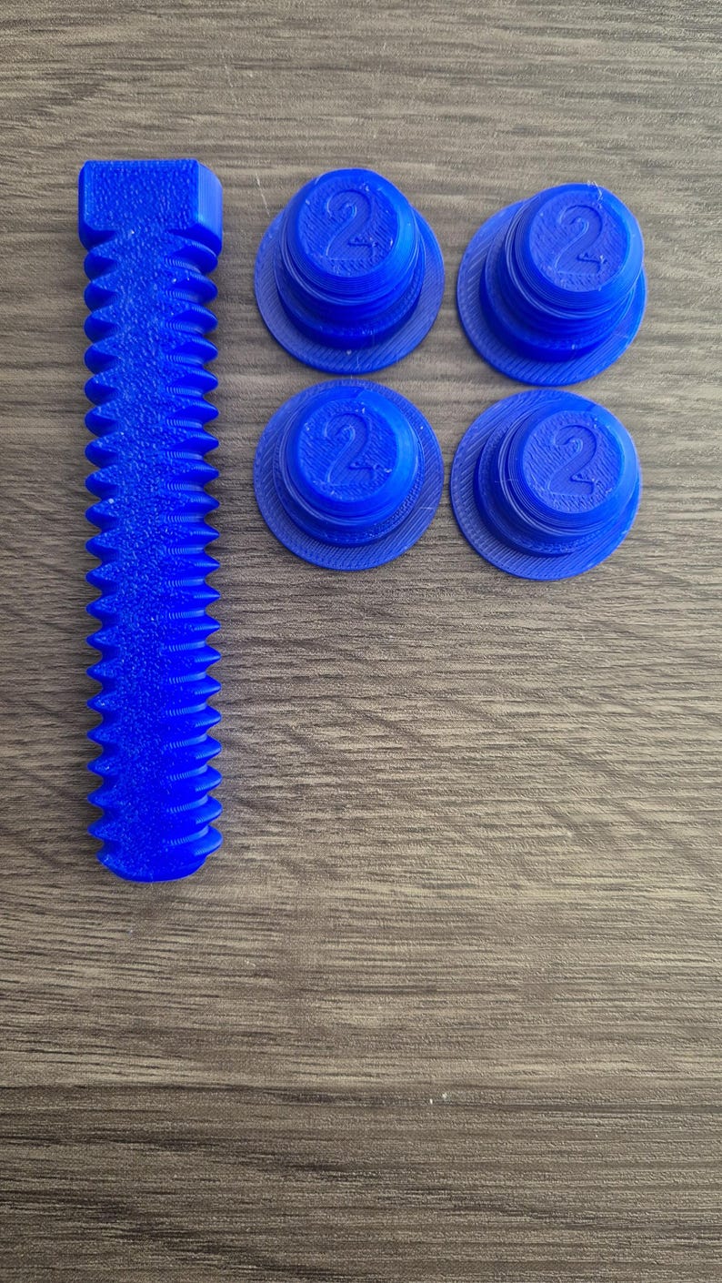 May include: Four blue plastic caps with the number "2" printed on them, and a blue plastic screw with a hexagonal head.