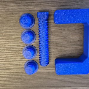 May include: A blue plastic clamp with a threaded screw and four blue plastic nuts. The clamp is made of a textured plastic.