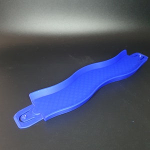 May include: A blue plastic track piece for a marble run toy. The track piece is curved and has a textured surface.