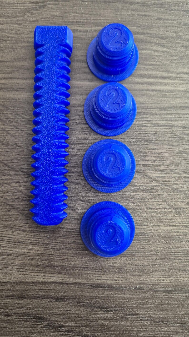 May include: Four blue plastic caps with the number "2" printed on them and a blue plastic screw with a threaded design.
