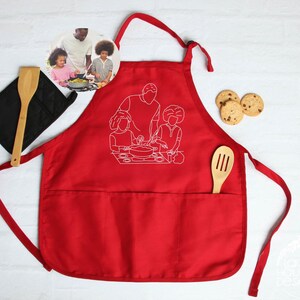 a red apron with a picture of two people cooking