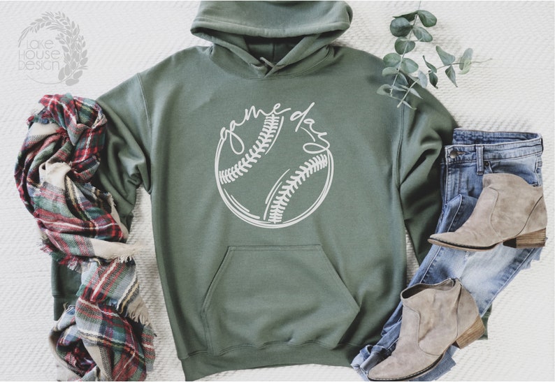 May include: A green hooded sweatshirt with a white baseball graphic and the text "game day" on the front.