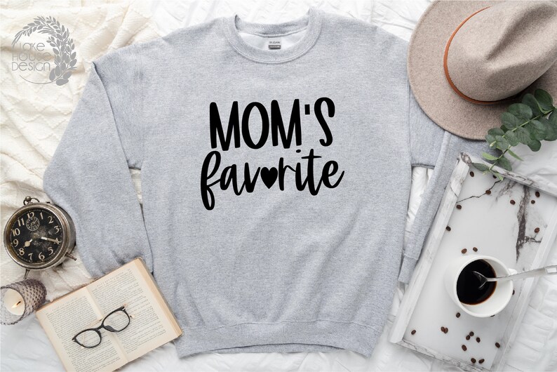 May include: Gray sweatshirt with the text "MOM'S favorite" in black lettering with a small heart in the middle of the word "favorite".