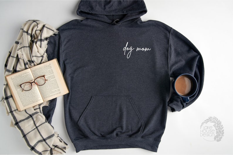 May include: A dark gray hooded sweatshirt with a white cursive inscription that reads "dog mom".