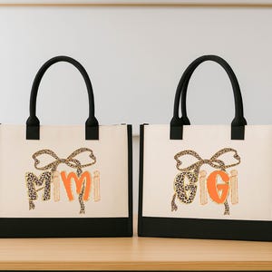 Two beige tote bags with black handles and leopard print designs, featuring the text "GIGI" in orange and black.