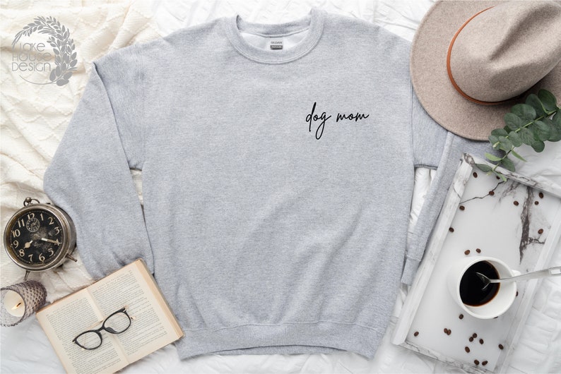 May include: A gray sweatshirt with the text "dog mom" in black script on the front.